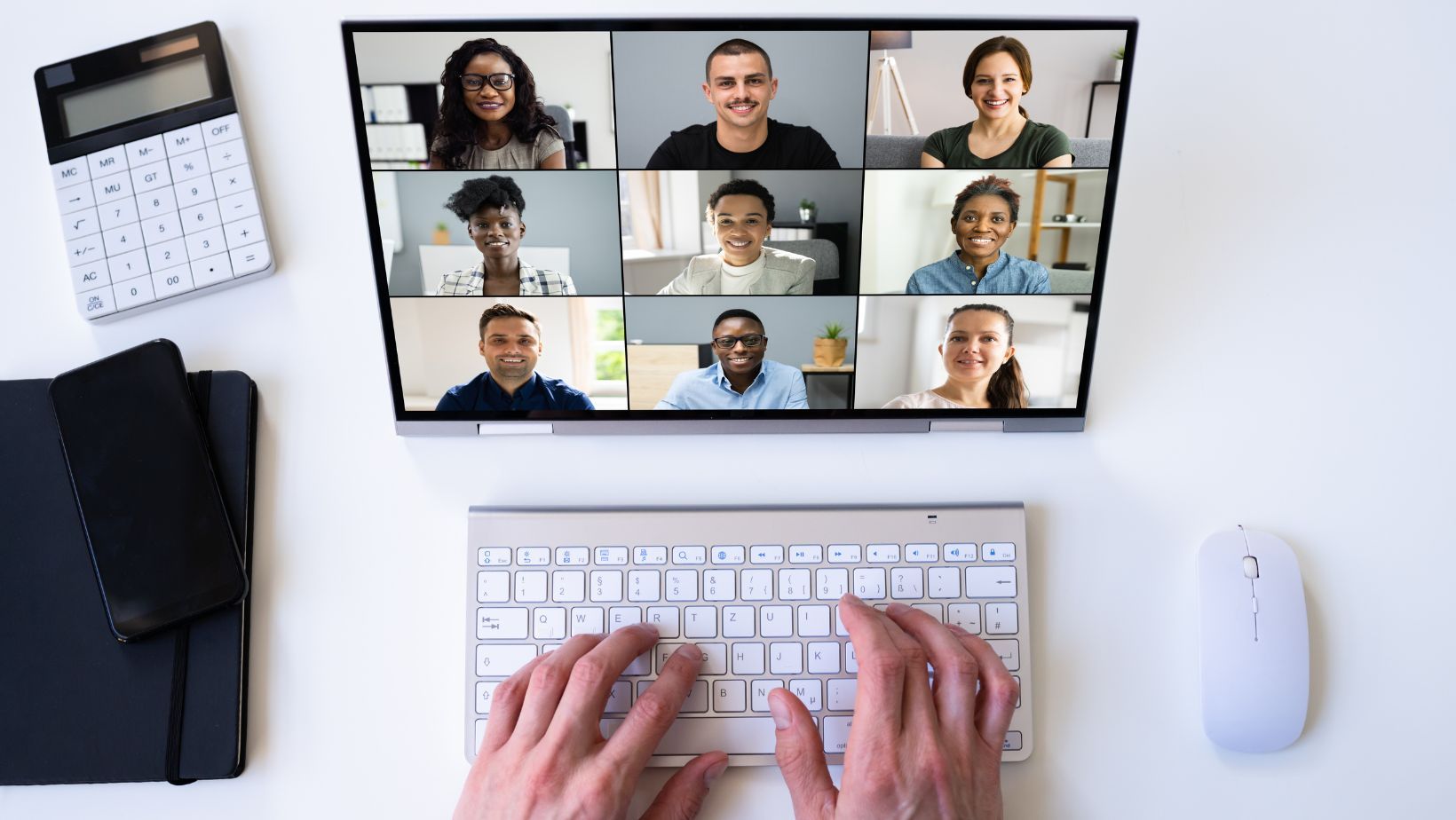 A shot of a computer screen with multiple people in a virtual meeting.
