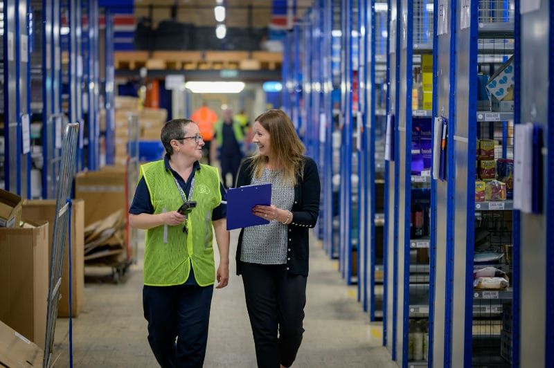 People Walking Through a Store Warehouse