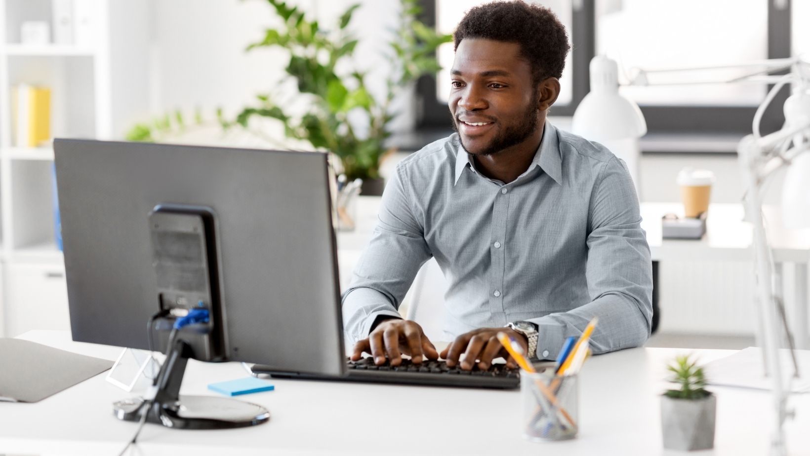 Real estate agent uploading images into SeekBeak on his computer.